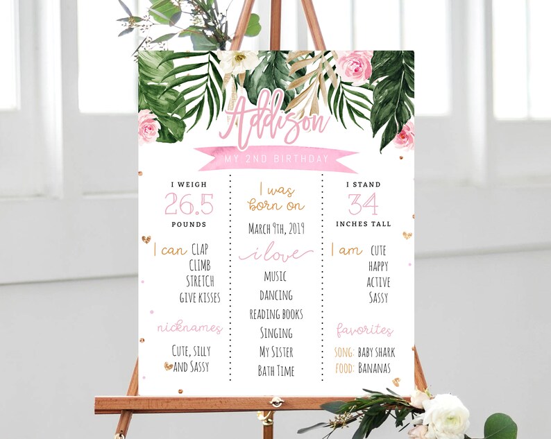 May include: A pink and green printable birthday sign for a 2-year-old girl named Addison. The sign includes details about her weight, height, and things she loves to do. It features a tropical theme with palm leaves and flowers.