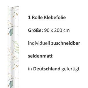 May include: A roll of adhesive film with a watercolor floral design in shades of green and gold. The roll is 90 inches by 200 inches and is made in Germany. The text on the image reads: "1 Rolle Klebefolie", "Gr&ouml;&szlig;e: 90 x 200 cm", "individuell zuschneidbar", "seidenmatt", "in Deutschland gefertigt".