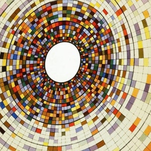 May include: A circular design with a white center and concentric rings of colored squares. The squares are in various shades of red, orange, yellow, green, blue, purple, and brown. The design is reminiscent of a target or a bullseye. The text "GENERAL DYNAMICS" is printed in black at the bottom of the image.