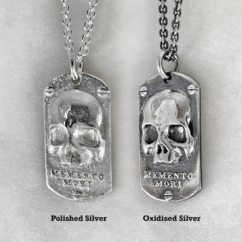two dog tags showing the different finishes, polished silver or oxidised silver by jewel thief brighton