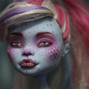 May include: Close-up of a doll's face with blue skin, pink and white makeup, and pink and white hair. The doll has a unique, slightly scary expression.