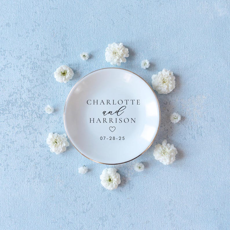 Personalized ceramic ring dish with custom names and date — engagement gift, wedding gift, bridesmaid gift, jewelry holder tray.

Custom round jewelry dish with heart accent and names and date — personalized engagement gift for bride-to-be

White ceramic trinket dish for rings and jewelry — personalized names ring dish for bridal shower or proposal gift

Engagement ring holder dish with custom lettering — wedding keepsake gift for couples, bride, or bridesmaids