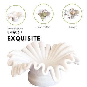 May include: A white marble bowl with a unique, ruffled design. The bowl is hand-crafted and heavy. Natural Stone UNIQUE & EXQUISITE