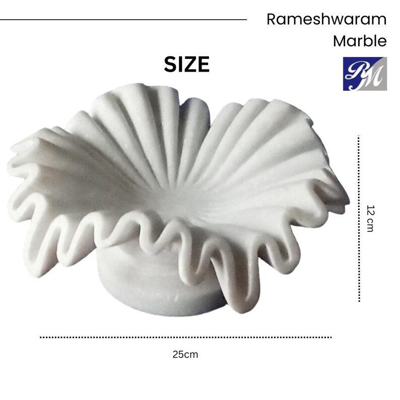 May include: White marble decorative bowl with a ruffled edge. The bowl is 12 inches in diameter and 25 inches wide.