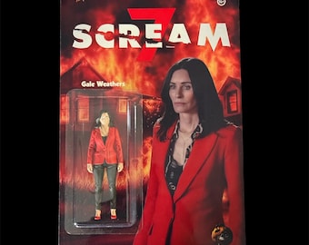 May include: A packaged action figure featuring Gale Weathers from the movie "Scream 7". The figure is in a clear plastic case with a red and white graphic background. The packaging includes the movie title and a picture of the character.