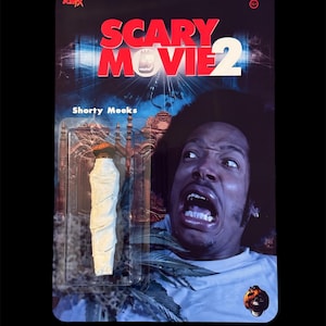 May include: A Scary Movie 2 action figure featuring Shorty Meeks. The packaging includes the movie title in red and white, and a close-up of Shorty's face. The figure is a white, rolled item.