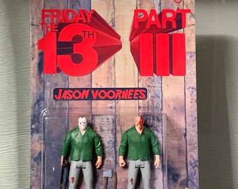 May include: A plastic package with a red and white design featuring the text "Friday the 13th Part III" and "Jason Voorhees". The package contains two action figures of Jason Voorhees, one with a hockey mask and one with a bloody face.
