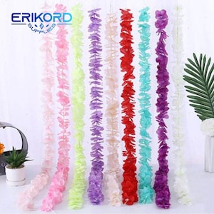 May include: A set of 8 artificial flower garlands in various colors, including pink, purple, light blue, red, and white. The garlands are made of paper and are strung together to create a long, flowing garland. The garlands are perfect for adding a touch of color and whimsy to any event or party.