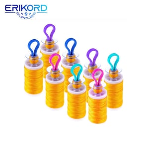 May include: Eight yellow thread spools with colorful plastic lids. The spools are arranged in a staggered pattern on a white background.