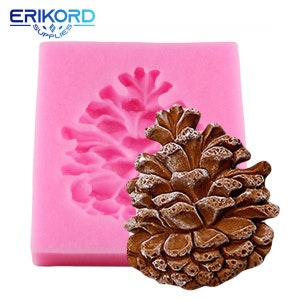 May include: Pink silicone mold with a detailed pine cone design. The mold is used for making cake decorations or other edible crafts.