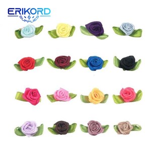May include: Assortment of 12 small, fabric rose embellishments with green leaves. The roses are in various colors, including red, pink, blue, yellow, purple, and brown.