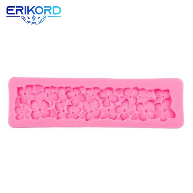 May include: Pink silicone mold with a design of a row of small flowers. The mold is rectangular and has a smooth surface.