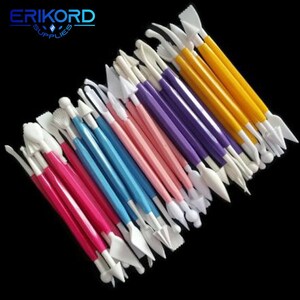 May include: A set of 20 colorful plastic cake decorating tools with various shapes and sizes. The tools are arranged in a fan shape with the handles facing up. The tools are white, yellow, pink, blue, and purple. The tools are labeled "ERIKORD SUPPLIES".