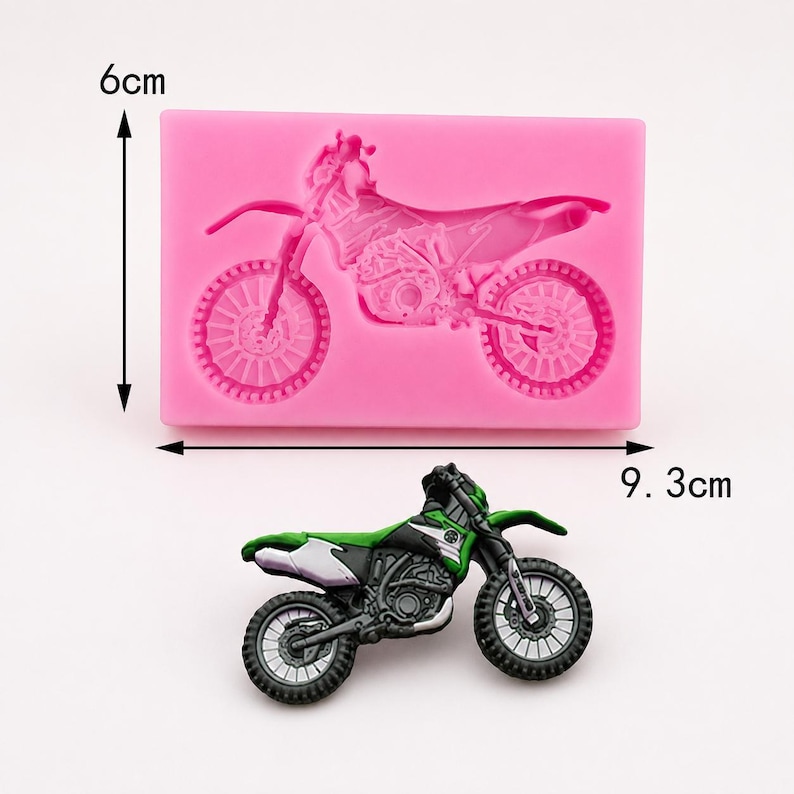 May include: A pink silicone mold in the shape of a motorcycle, measuring 9.3 cm long and 6 cm high. A green, black, and white motorcycle is placed below the mold. The motorcycle has detailed features.