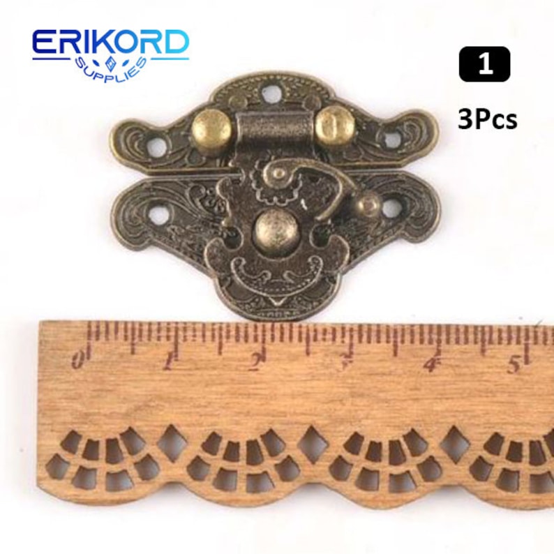 May include: Three antique-style brass latch clasps with ornate designs. Each clasp has a hinged lid and a decorative knob. The clasps are approximately 2 inches in length.
