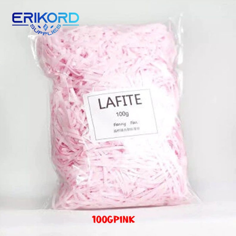 May include: A bag of pink shredded paper, labelled "LAFITE 100g Fancy Paper", with the brand name "ERIKORD SUPPLIES" at the top. The bag is labelled "100GPINK".