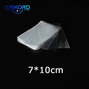 May include: A stack of clear plastic bags, 7 cm by 10 cm, for packaging small items.