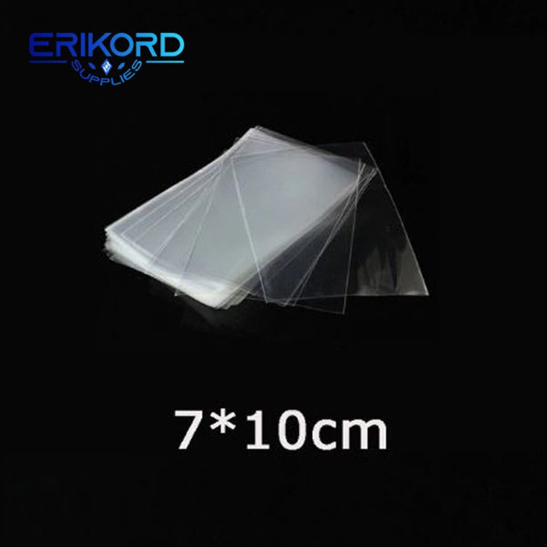 May include: A stack of clear plastic bags, 7 cm by 10 cm, for packaging small items.