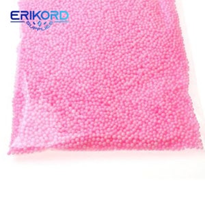 May include: A close-up of a bag filled with pink foam balls. The bag is clear plastic and the foam balls are small and round.