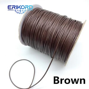 Puede incluir: Un carrete de cord&oacute;n de cuero marr&oacute;n. El cord&oacute;n est&aacute; enrollado alrededor de un carrete de cart&oacute;n. El cord&oacute;n tiene un grosor de aproximadamente 3 mm.