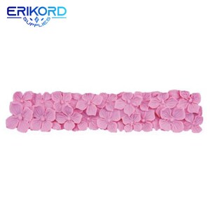 May include: Pink silicone mold with a design of a row of flowers. The mold is for making cake decorations or other edible items.
