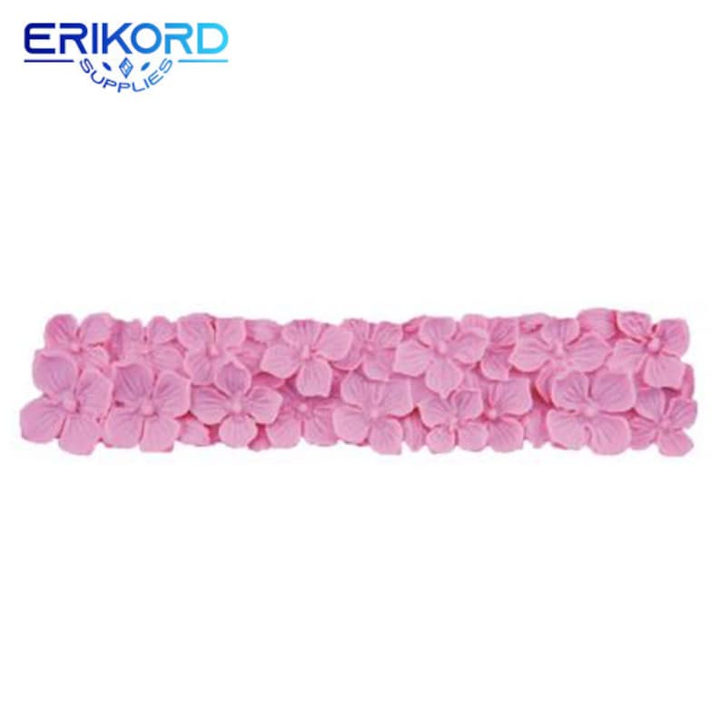 May include: Pink silicone mold with a design of a row of flowers. The mold is for making cake decorations or other edible items.