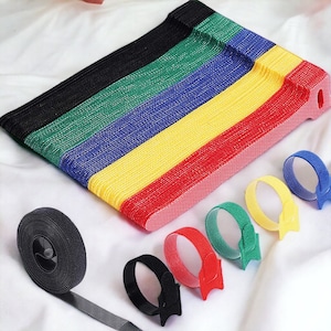 以下が含まれることがあります： 黒、緑、青、黄、赤のカラフルな再利用可能なケーブルタイのセット。タイは柔らかく柔軟な素材で作られており、コードやケーブルの整理に最適です。