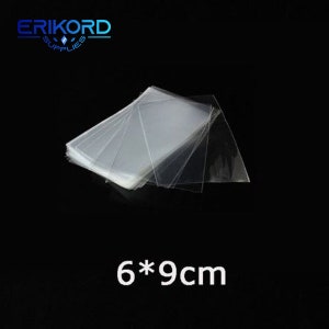 May include: A stack of clear plastic bags, 6 by 9 centimetres in size.