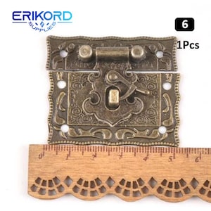 May include: Antique brass latch with ornate floral design. The latch has two parts, a hinged top and a bottom piece with a hook. The latch is 6 cm long and 4 cm wide. 1Pcs.