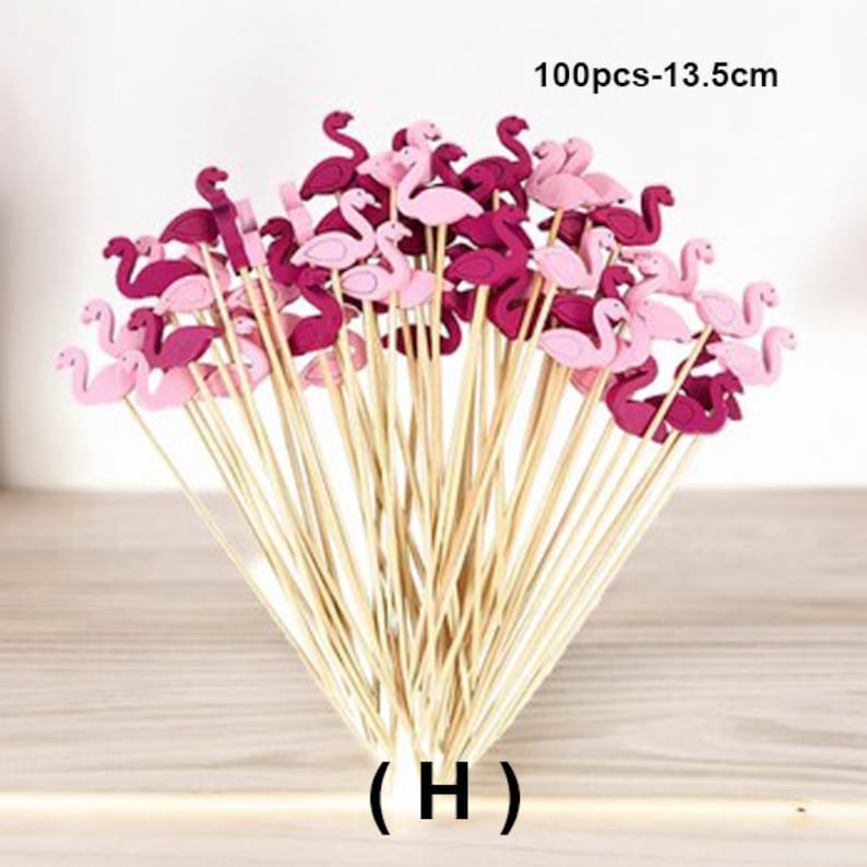 May include: 100 pink and red flamingo shaped cake toppers on wooden skewers. The skewers are 13.5 inches long.