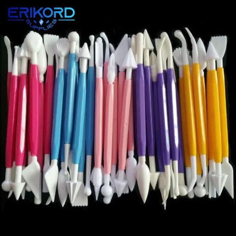 May include: A set of 30 assorted plastic cake decorating tools. The tools are in various colors, including pink, blue, purple, and yellow. The tools have different shapes and sizes, including round, oval, and pointed tips.