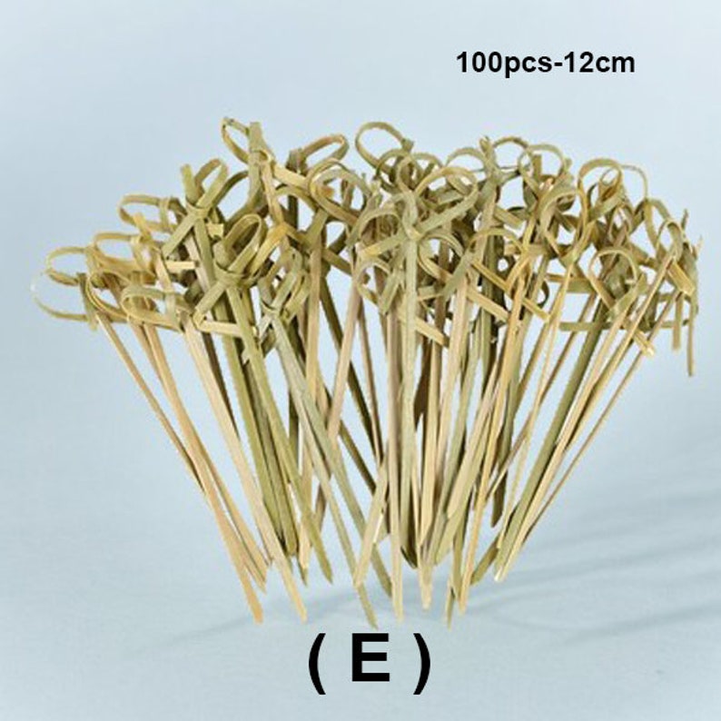 May include: A bundle of 100 natural bamboo skewers with a knotted loop at the top, measuring 12 inches in length.  The skewers are ideal for appetizers, fruit skewers, and other culinary creations.  (E)