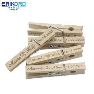 May include: Wooden clothespins with personalized names and dates, such as "Martin & Kelly" and "Amanda & Alex" with the date "13.07.2020".