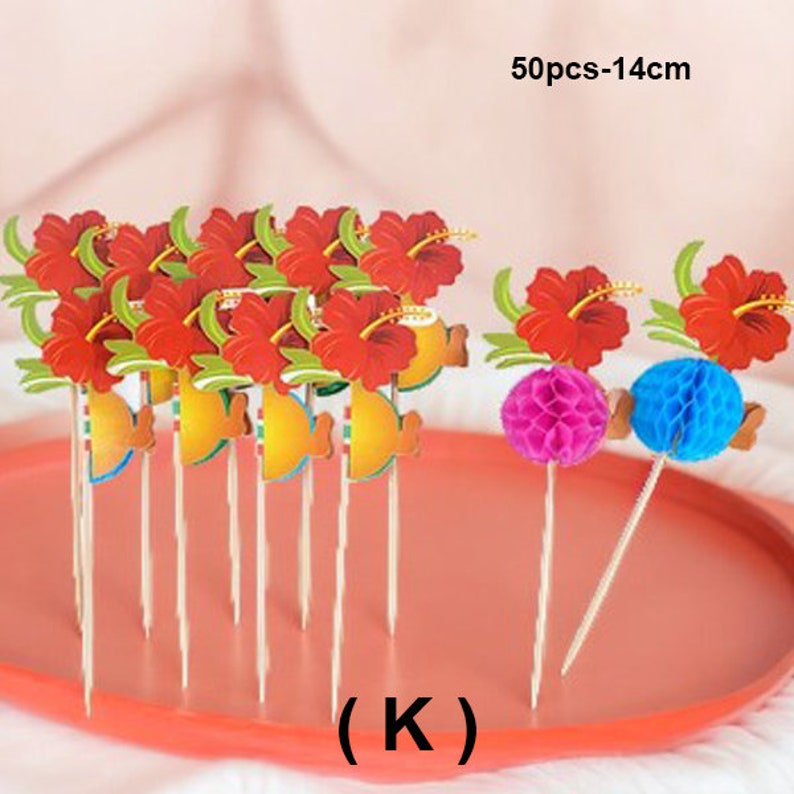 May include: A set of 50 red and green flower cupcake toppers with a yellow fish design. The toppers are on wooden skewers and are 14 cm long. The toppers are on a pink tray. (K)