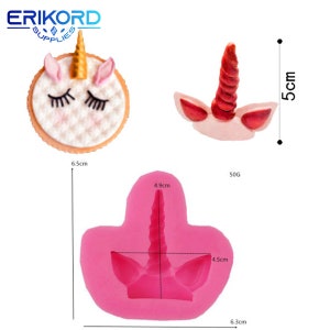 May include: Pink silicone mold for making unicorn horn and ears. The mold is 6.3 cm wide, 4.9 cm tall, and 4.5 cm deep. The mold is shown with a finished unicorn horn and ears made from pink and red fondant.
