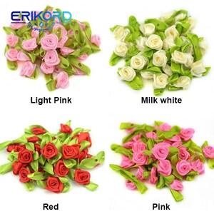 May include: Assortment of small, handmade fabric roses in four colors: light pink, milk white, red, and pink. Each rose has a green leaf stem.