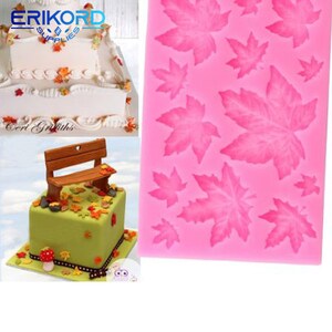 May include: Pink silicone mould with multiple maple leaf designs. The mould is used for making cake decorations.
