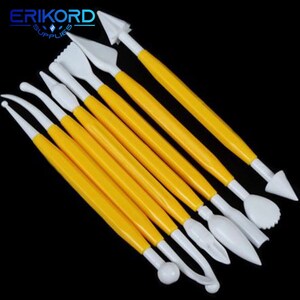 May include: Set of nine yellow and white plastic tools for decorating cakes and pastries. The tools have different shapes and sizes, including a ball, a heart, a leaf, and a star.
