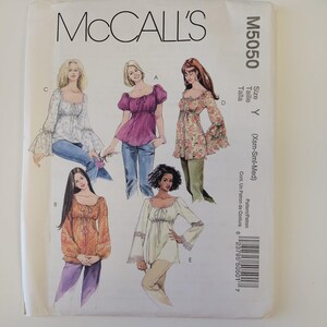 May include: McCall's M5050 sewing pattern envelope featuring illustrations of five different blouse styles with long sleeves, scoop necklines, and tie-front details. The pattern is sized Y for Xsm-Sml-Med and includes a barcode on the side.