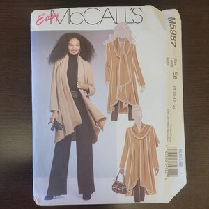 May include: A McCall's M5987 sewing pattern envelope for a long, open-front cardigan with a draped collar. The cover features illustrations and a photograph of the garment in tan, worn over a black turtleneck and black trousers, size BB 8-10-12-14.
