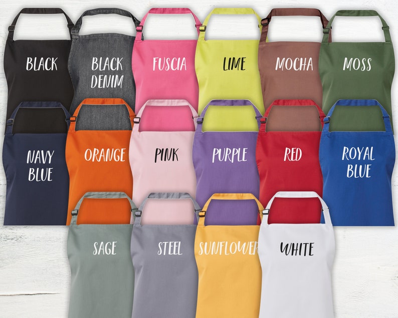 May include: A set of 15 colorful aprons with different colors and text. The colors include black, denim, fuchsia, lime, mocha, moss, navy blue, orange, pink, purple, red, royal blue, sage, steel, sunflower, and white.