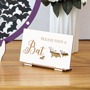 Gothic wedding sign for guest book with bat tokens. Perfect for halloween and spooky-themed weddings.