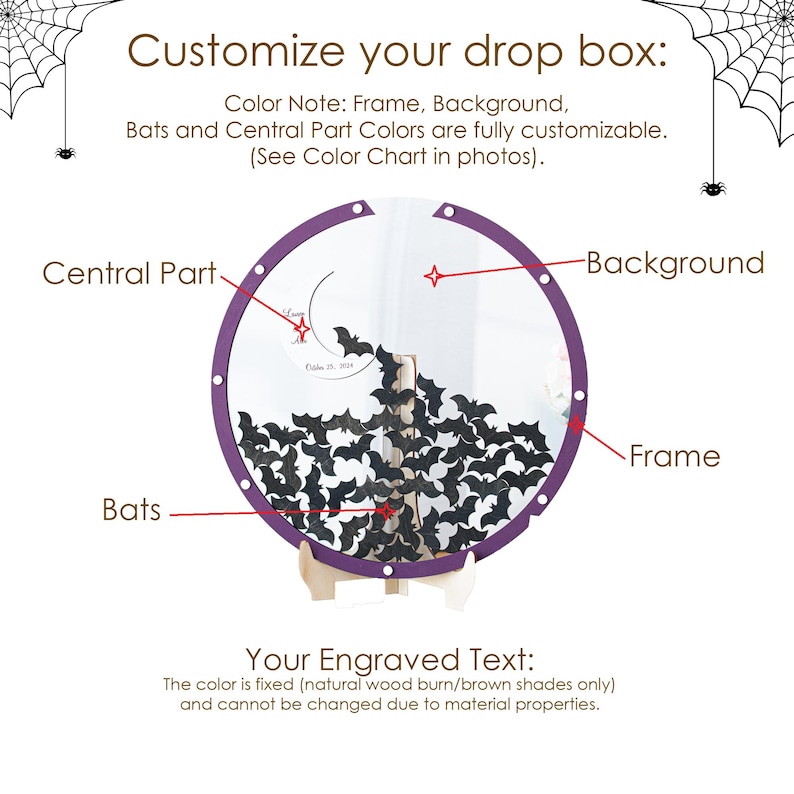 May include: A circular drop box with a purple frame, a clear background, and numerous black bat-shaped cutouts inside. The display features a central part with engraved text, supported by a light-colored wooden stand. Spider web graphics appear in the top corners.