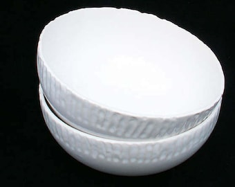 Handmade white ceramic bowl with rustic fluted or ribbed edge