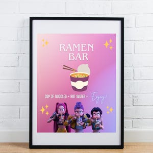May include: Framed poster with a pink and purple gradient background. The poster features the words "RAMEN BAR" and an illustration of a cup of noodles with chopsticks. Below the illustration are three animated figures holding cups of noodles. The text "CUP OF NOODLES + HOT WATER = Enjoy!" is also included.
