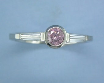 Natural Pink diamond ring with two white tapering baguette cut diamonds by John R Fox