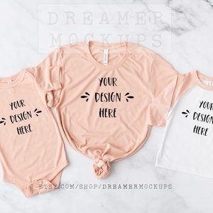 May include: Three peach-colored shirts with the text "Your Design Here" on a white marble background. The shirts are a long-sleeved adult shirt, a short-sleeved baby onesie, and a long-sleeved toddler shirt with a white and peach color block design.