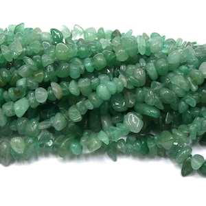 May include: A strand of green aventurine chip beads. The beads are irregular in shape and have a smooth, polished finish.