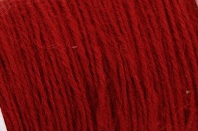 May include: A spool of deep red embroidery floss.