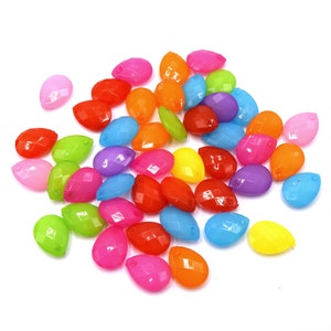 May include: A collection of colorful teardrop-shaped beads, featuring a variety of bright hues including pink, orange, yellow, green, blue, and purple.
